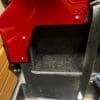 Close-up of a red and black industrial or mechanical component.
