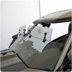 Close-up of a car's windshield with attached clip-on sunshades.