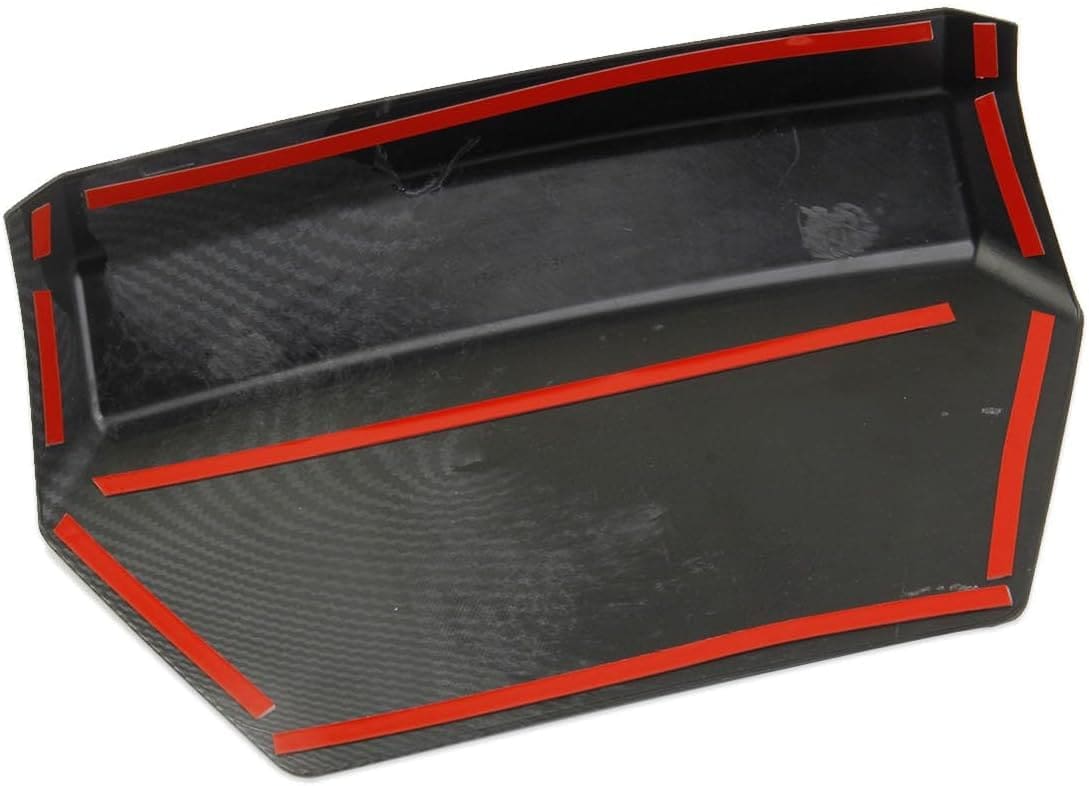Close-up of a carbon fiber car spoiler with red trim.