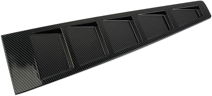 Close-up of a black carbon fiber car spoiler with aerodynamic fins.