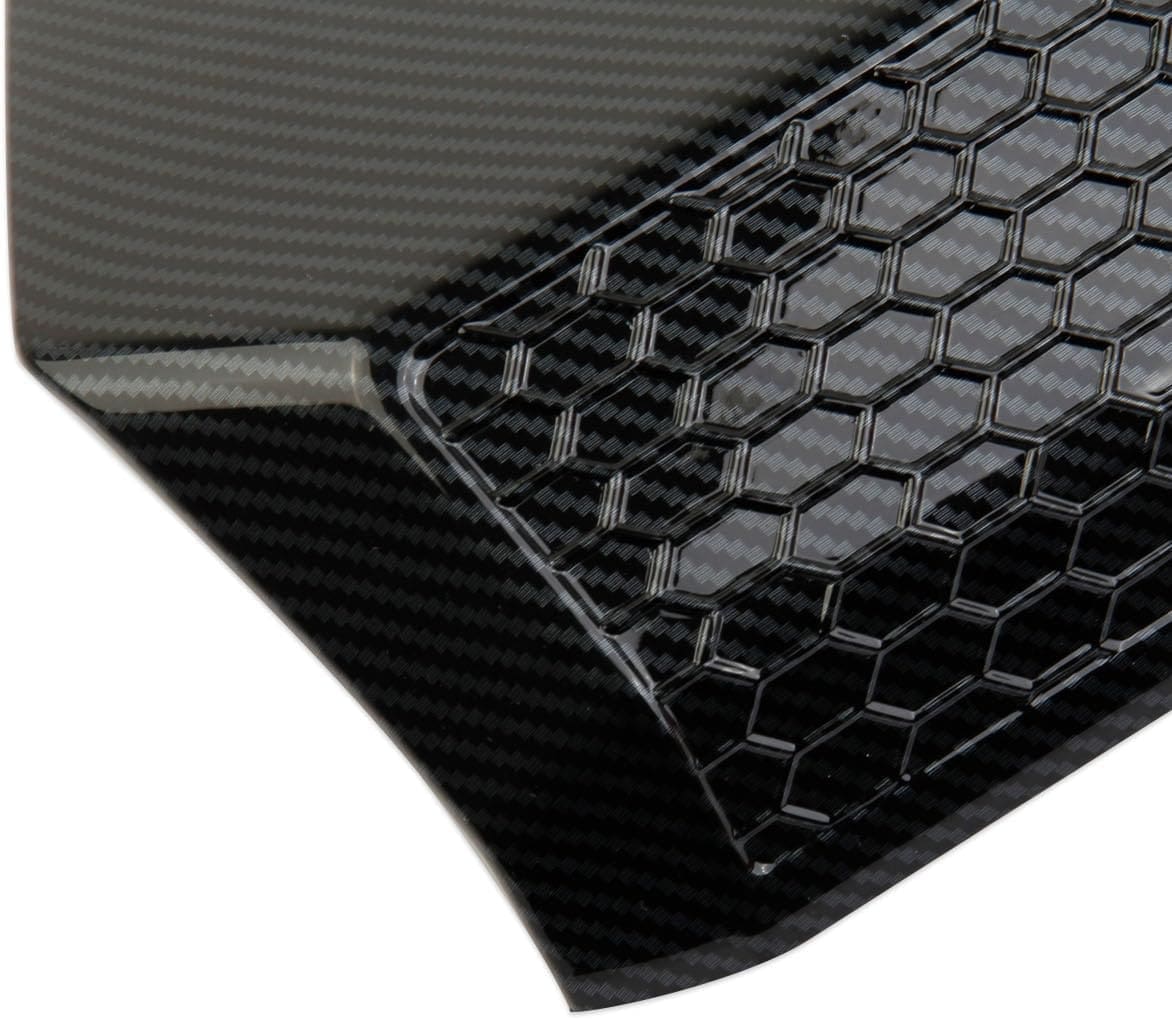 Close-up of a carbon fiber car part with hexagonal pattern.