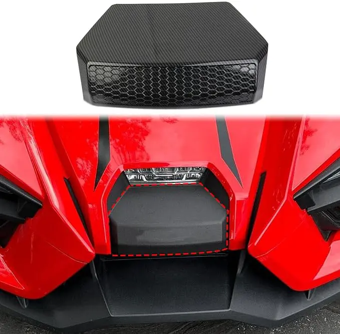 Close-up of a red vehicle's front grille with a black component above it.