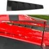 Black aerodynamic rear window louvers on a red car.