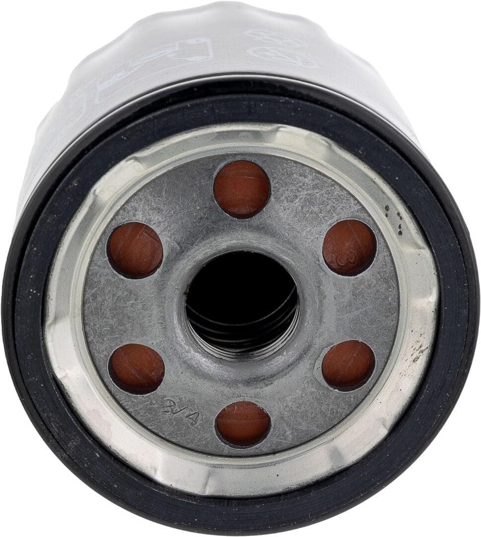 Close-up of an oil filter's metal base with circular holes and gasket.
