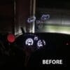 Car dashboard display before modifications in a dark setting.