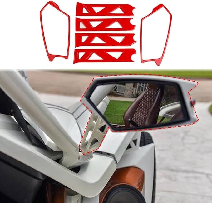 Close-up of a car side mirror with a person visible inside the vehicle.