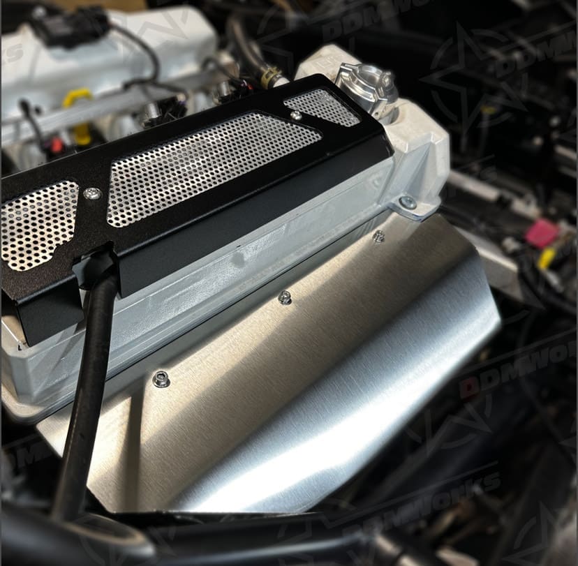 Close-up of a car engine with a focus on the air intake and surrounding components.