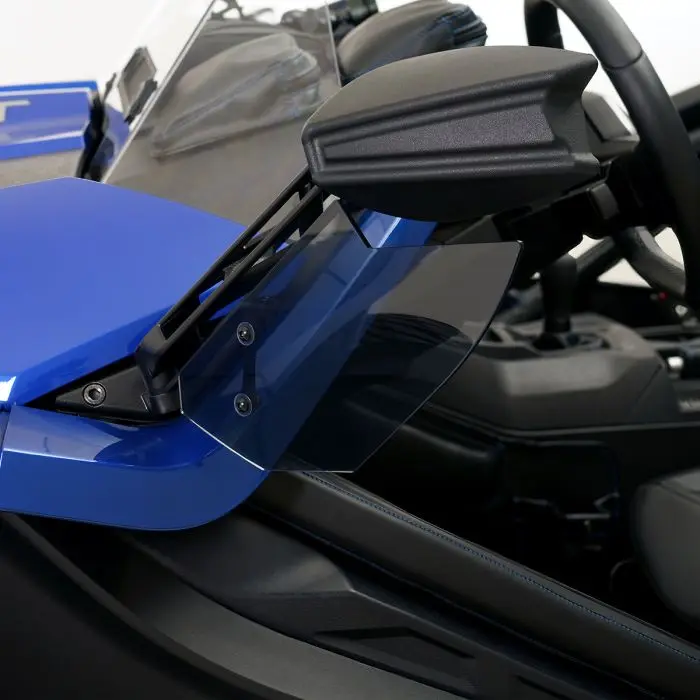 Close-up of a blue sports car's side mirror and window area.