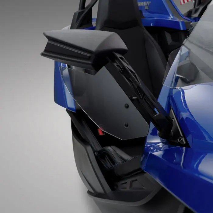 Close-up of a blue car's side mirror with integrated lighting.