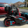 Custom three-wheeled motorcycle with vibrant red and turquoise accents.