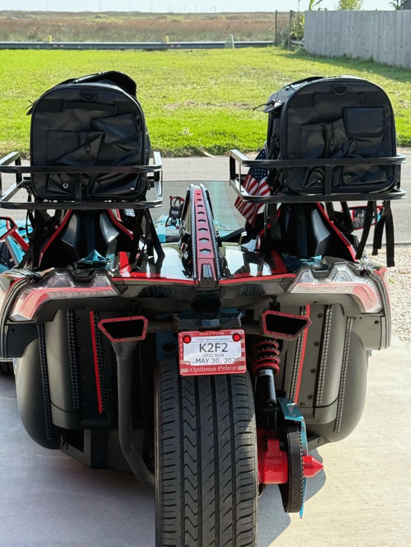 Rear view of two go-karts parked side by side under a canopy.