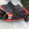 s-l1600 Electric go-kart covered with a black protective tarp.