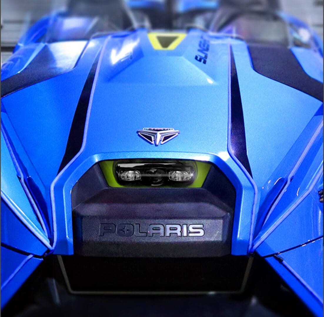 IMG_0910 Close-up of a blue Polaris vehicle's front engine detail.