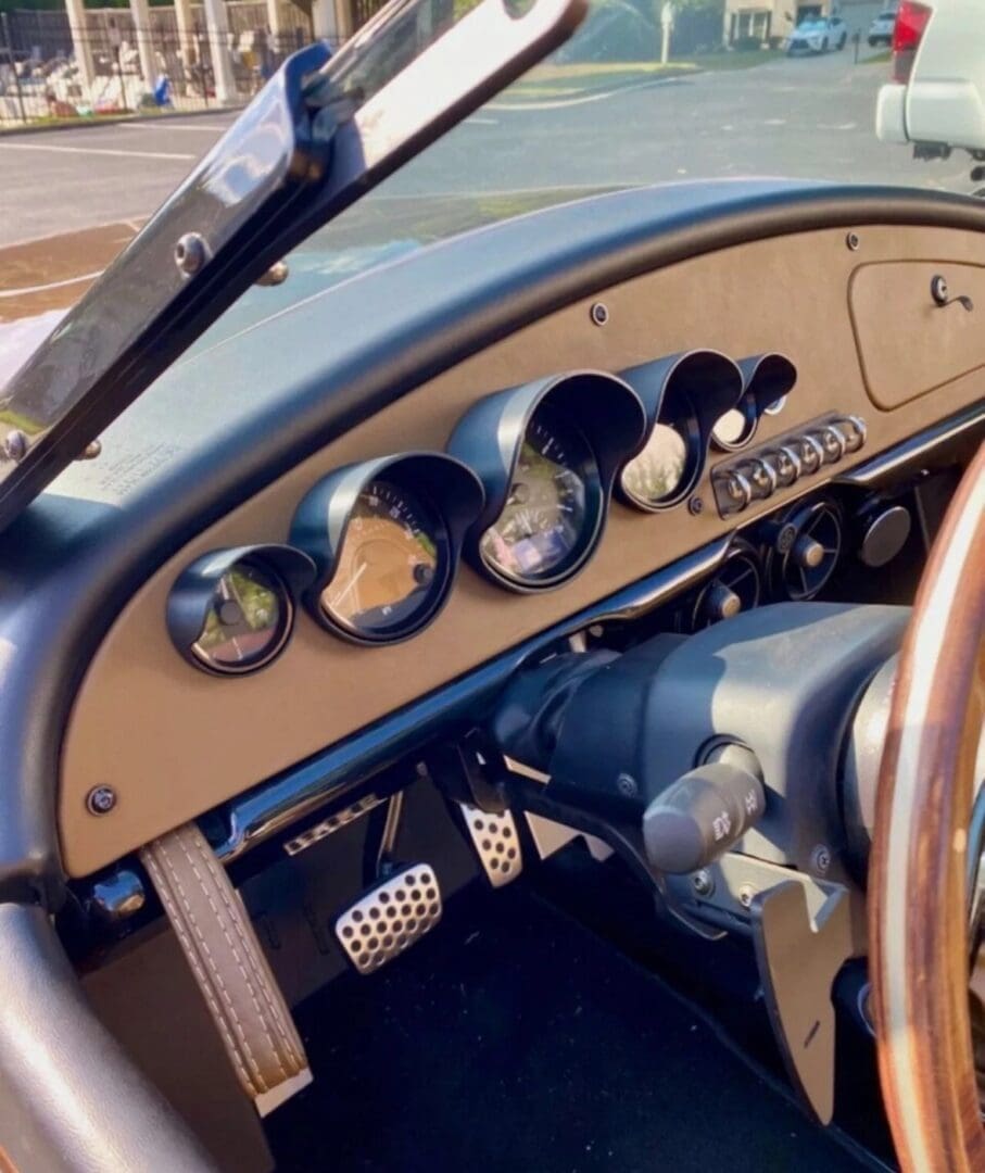 img_1061 Classic car dashboard with vintage gauges and wooden steering wheel.